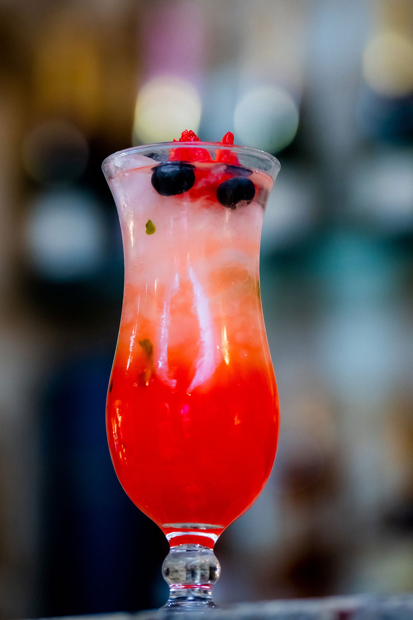 A colourful berry-garnished drink photographed for Seraphic Bistro